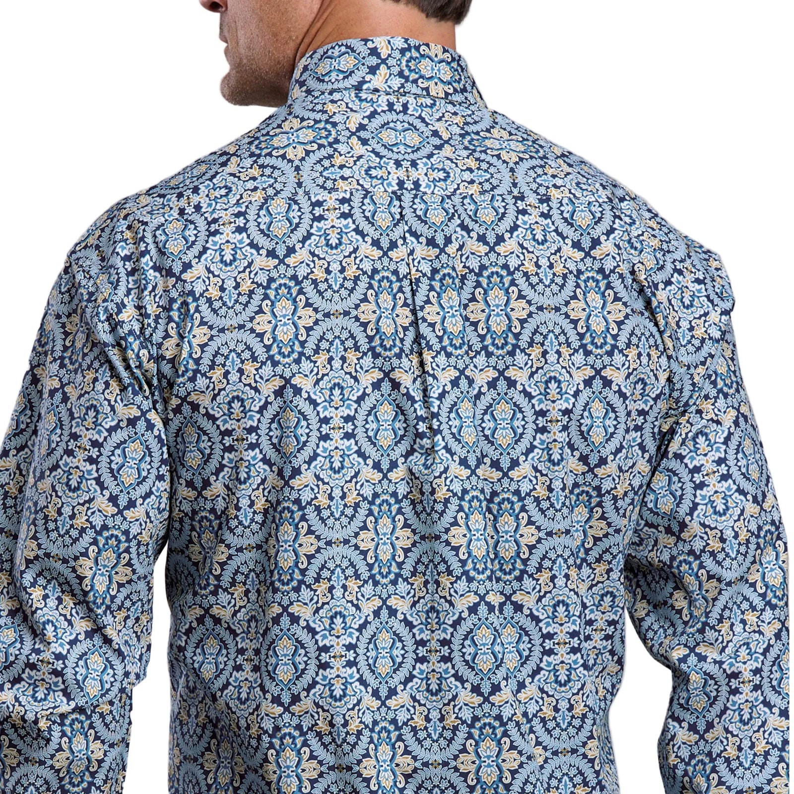 Man wearing a blue patterned shirt against a gray background