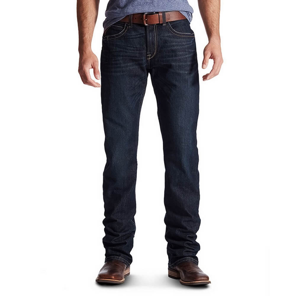 Ariat Men's Rebar M4 Lowrise Jean. A man wearing a pair of black, low-rise, boot-cut jeans with a belt and bootstraps.