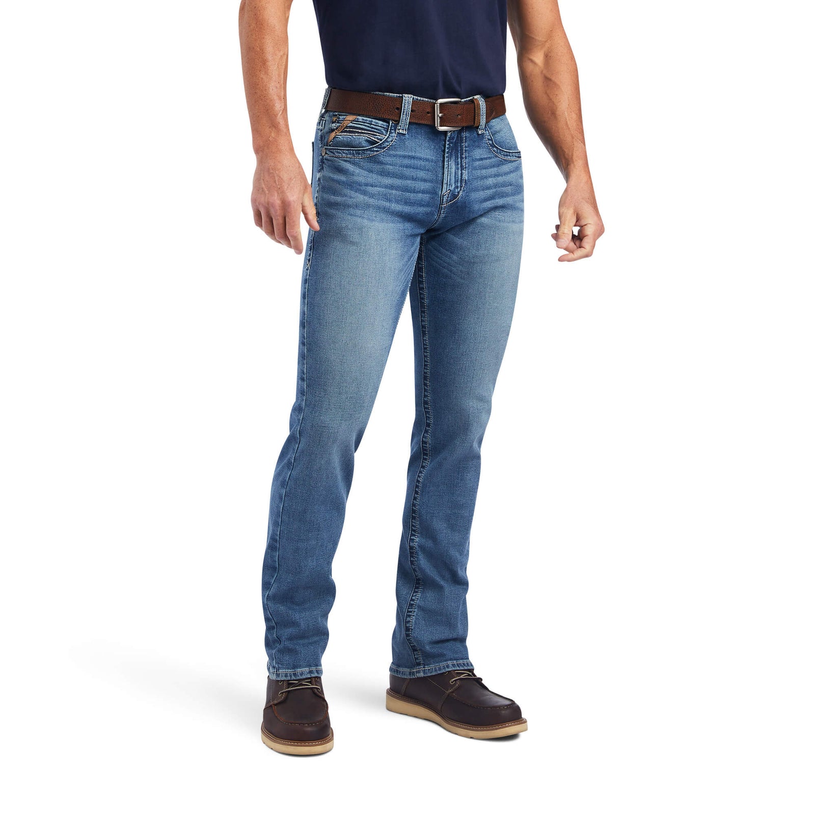 A man standing straight, wearing Ariat Men's M7 Wessley Straight Leg Jean with a belt and brown shoes.