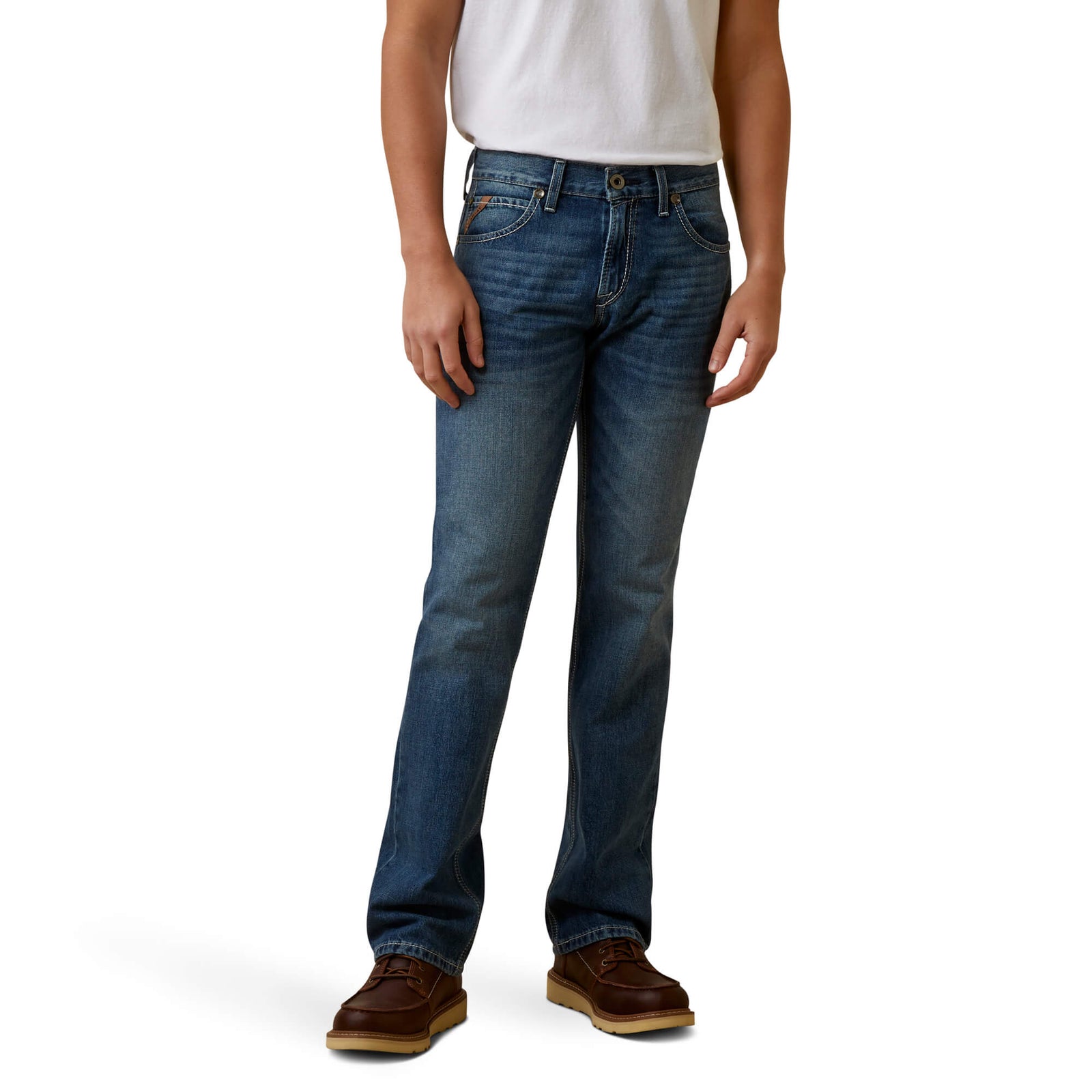 A man standing straight, wearing Ariat Men's Griffen M7 Straight Leg Jean and a white t-shirt, with no visible footwear.