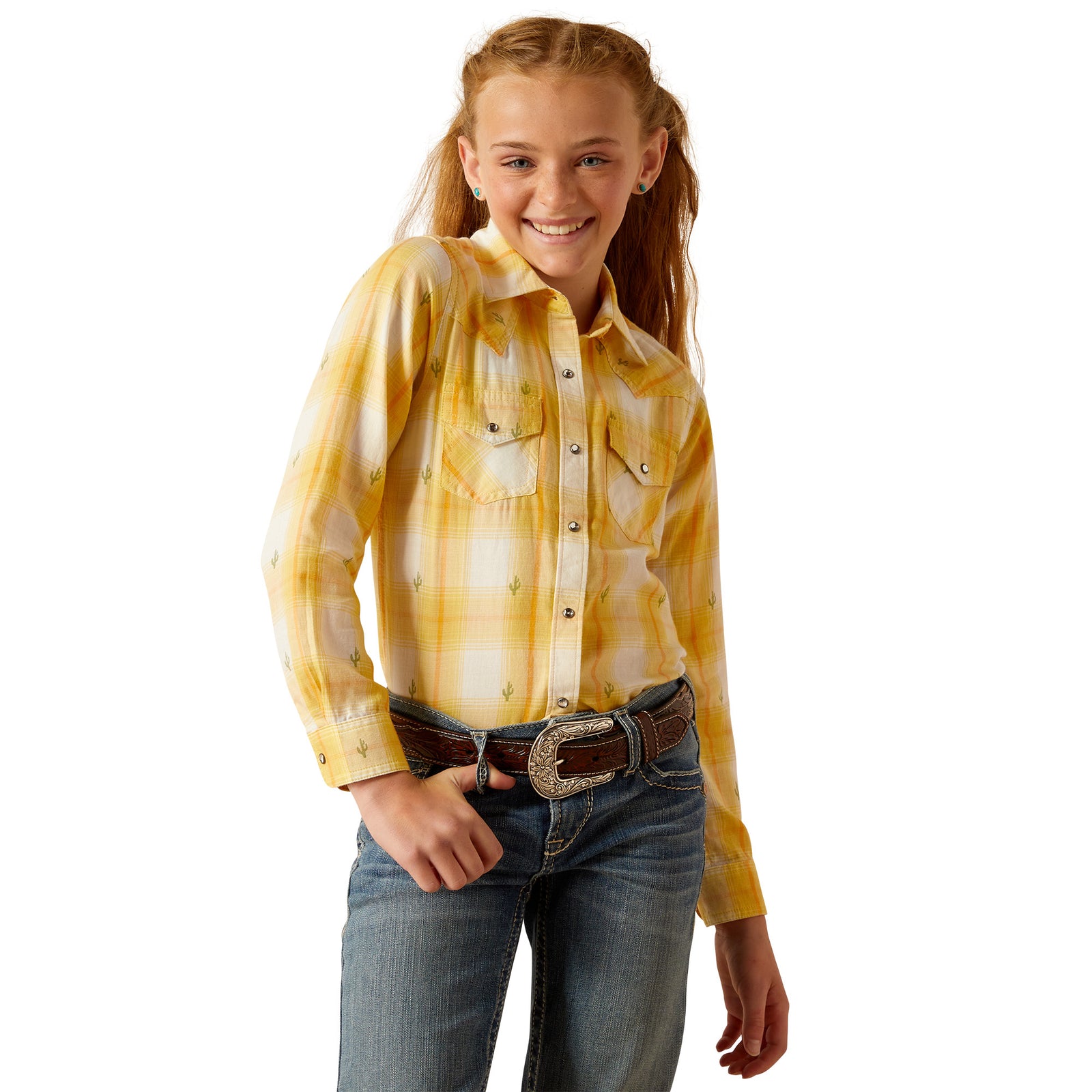 Ariat Girl's Glenrock Snap L/S Western Shirt. A girl wearing a long-sleeved plaid Western shirt in yellow and blue, with crystal snaps and chest pockets, paired with blue jeans.