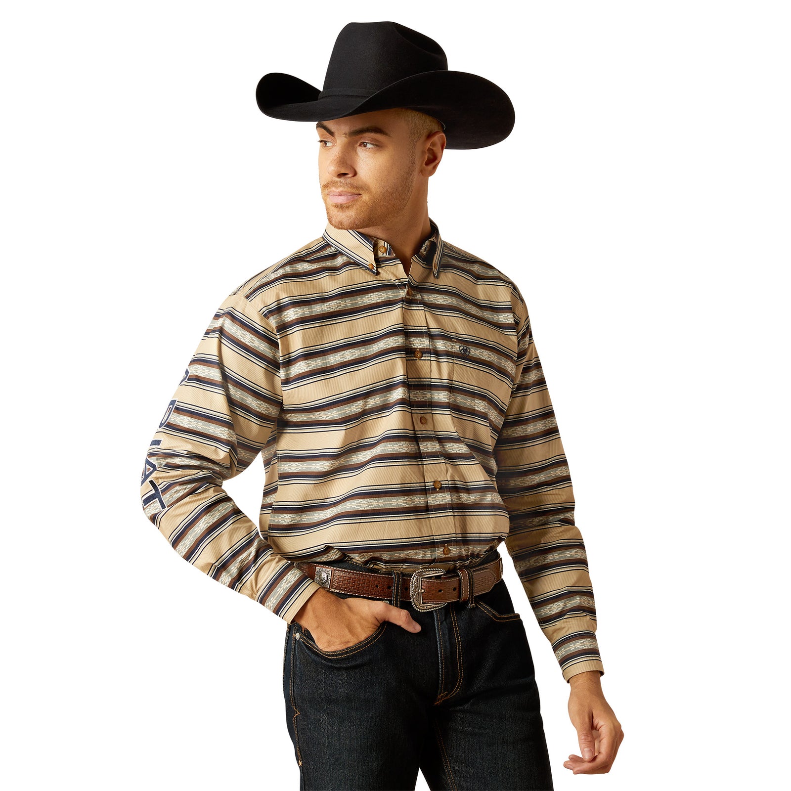 Ariat Men's Team Korbyn L/S Western Shirt. A man wearing a striped long-sleeved Western shirt with buttoned collar and sleeves, featuring Ariat brand embroidery. He is also wearing a black cowboy hat and blue jeans.