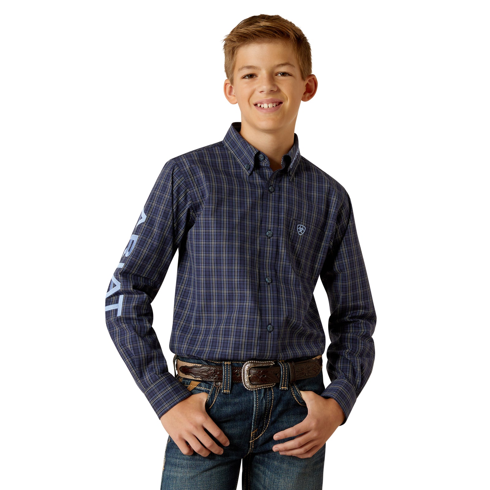 Ariat Boy's Pro Series Team Kolt L/S Western Shirt. A boy wearing a long-sleeved plaid Western shirt with buttoned collar points and sleeve embroidery.