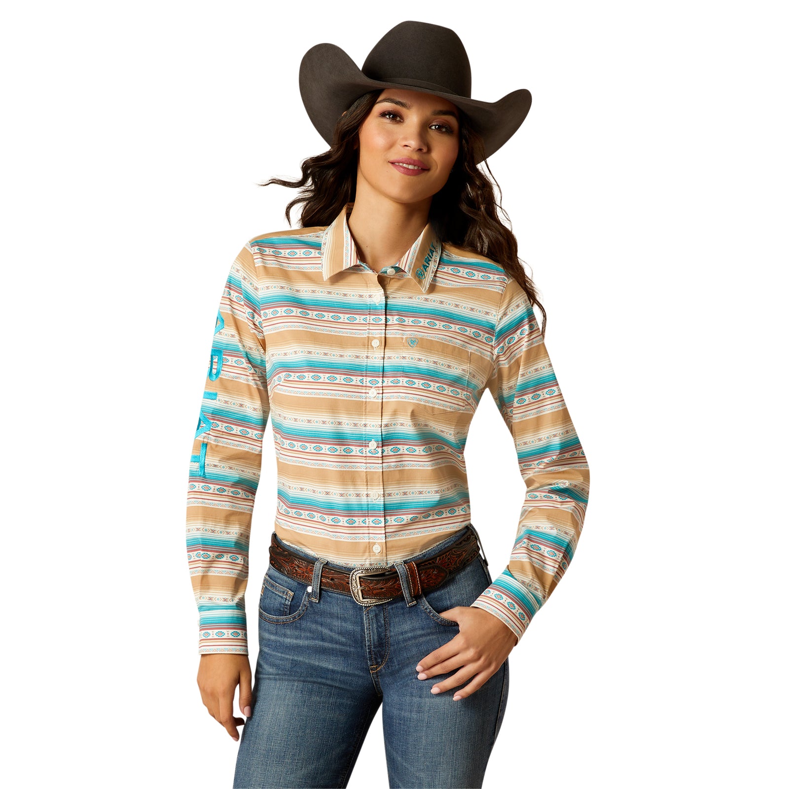 Ariat Women's Wrinkle Resist Team Kirby Stretch Shirt. A woman wearing a long-sleeved striped shirt with geometric patterns, predominantly in beige and blue colors, with a single chest pocket and a collar.