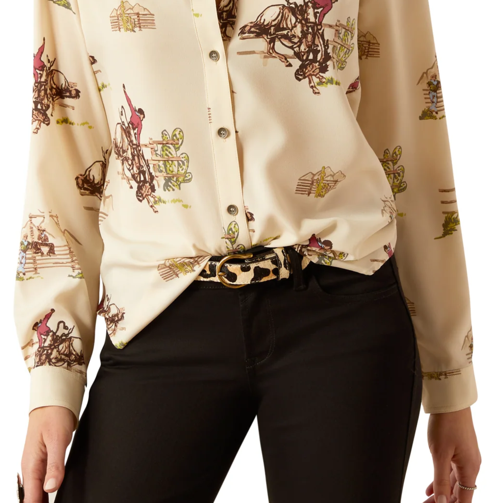 Beige shirt with horse and rider print worn by a person, paired with black pants on a white background