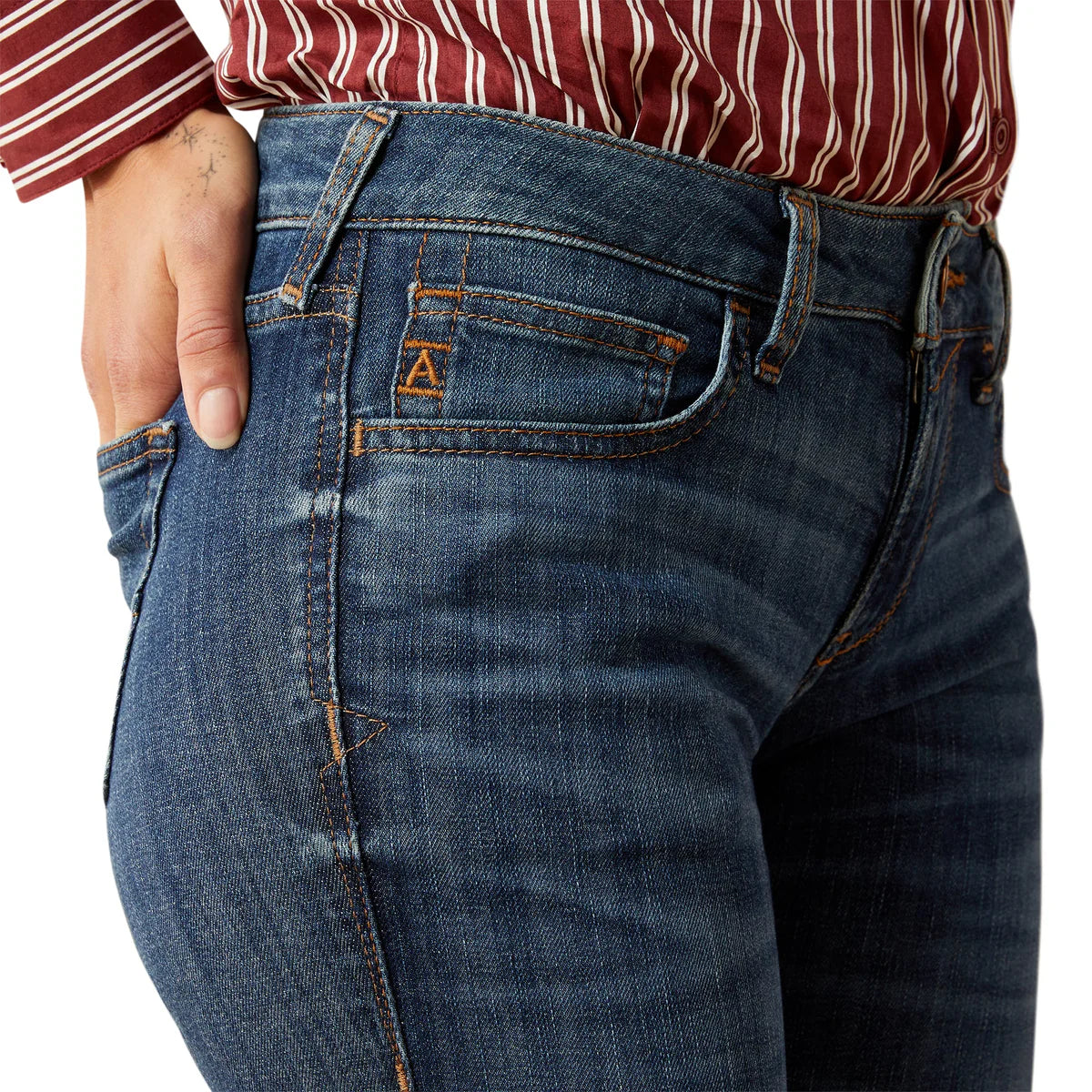 Close-up of blue jeans with a brand logo on a white background