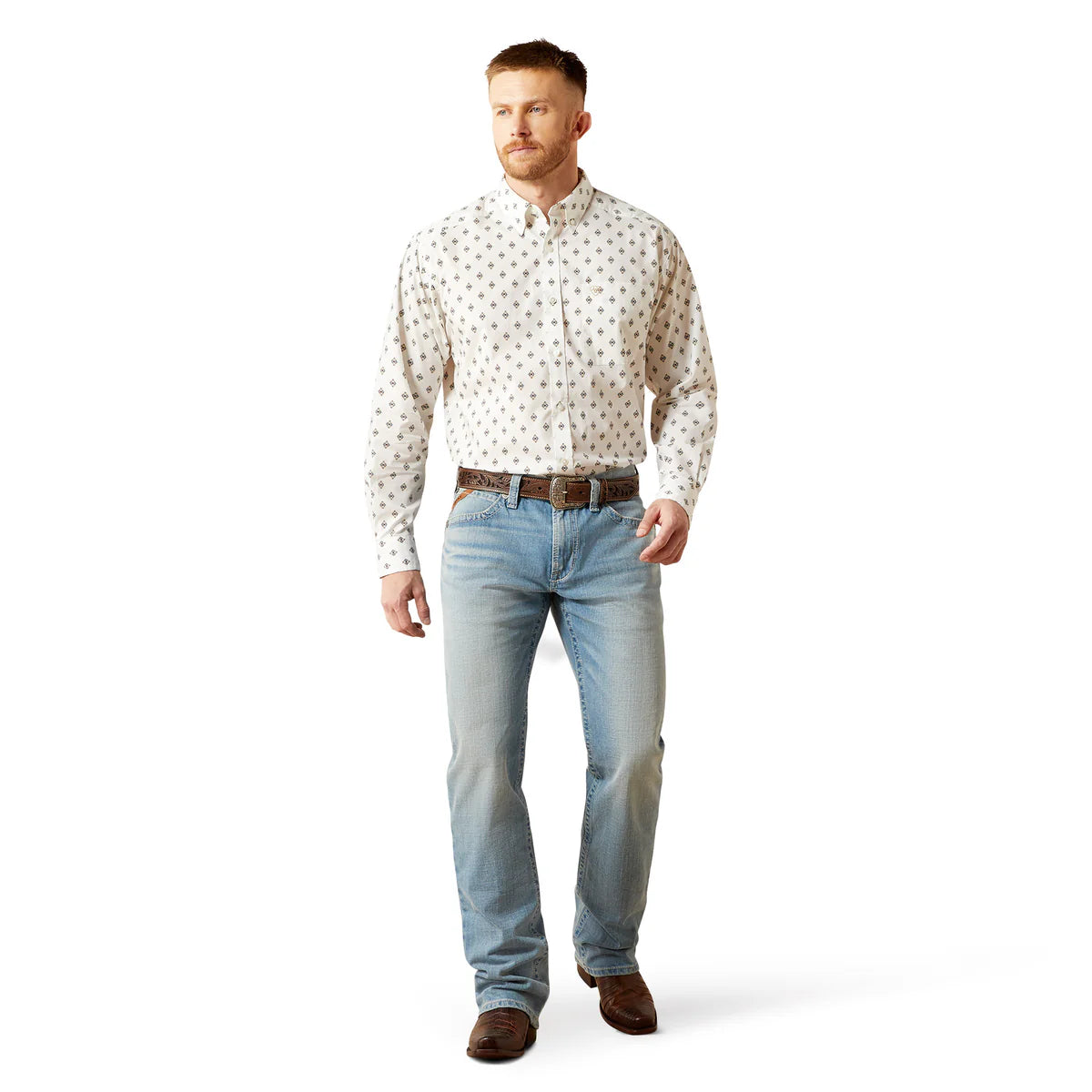 Man wearing a patterned shirt and jeans on a white background