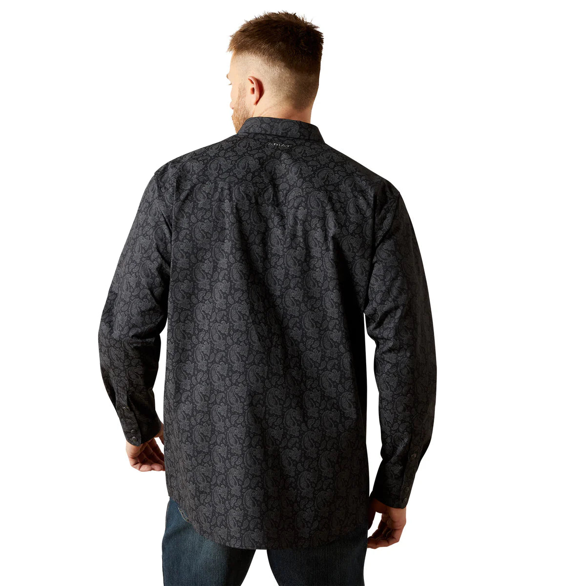 Man wearing a dark patterned shirt on a white background