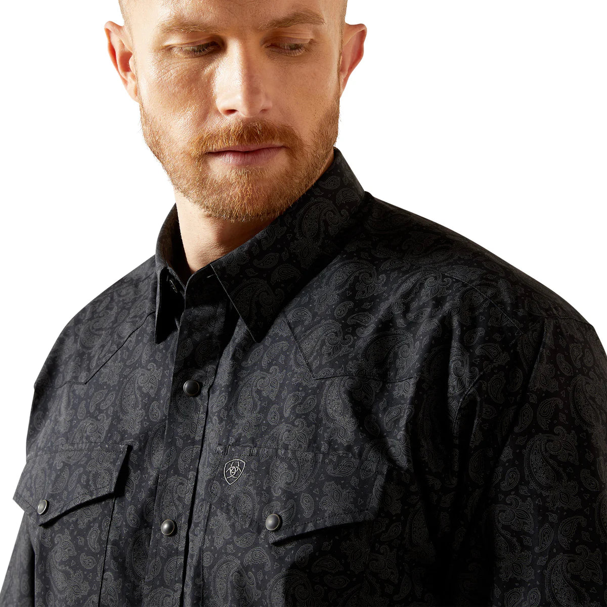 Man wearing a black patterned shirt on a white background