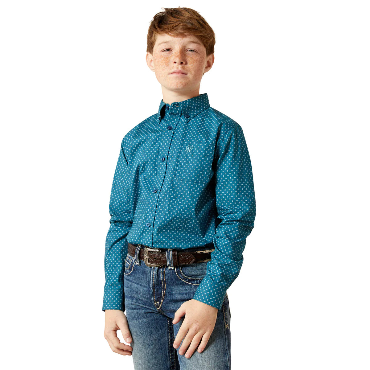 Young boy wearing a teal patterned shirt and jeans on a white background