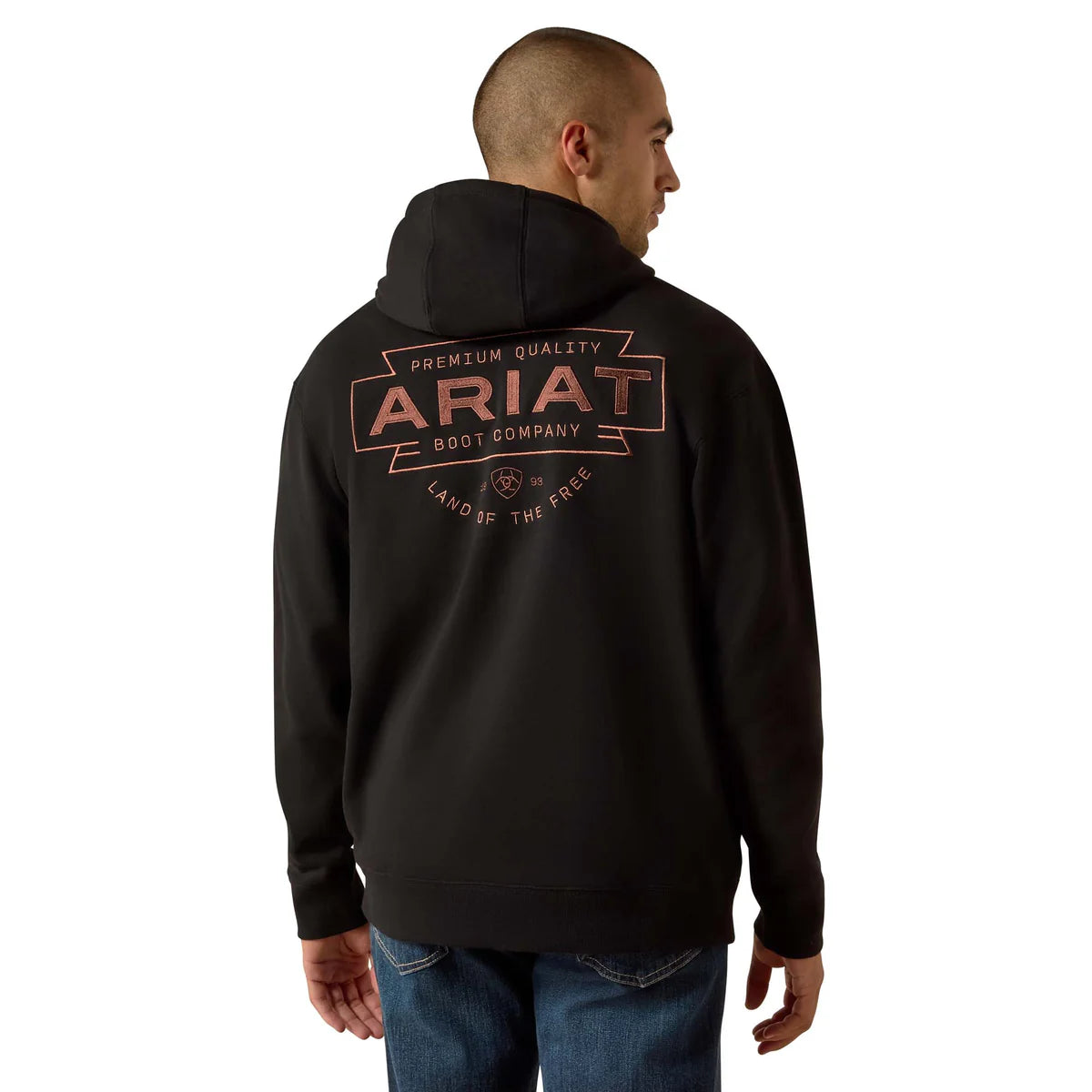 Person wearing a black hoodie with Ariat branding on the back, standing against a white background