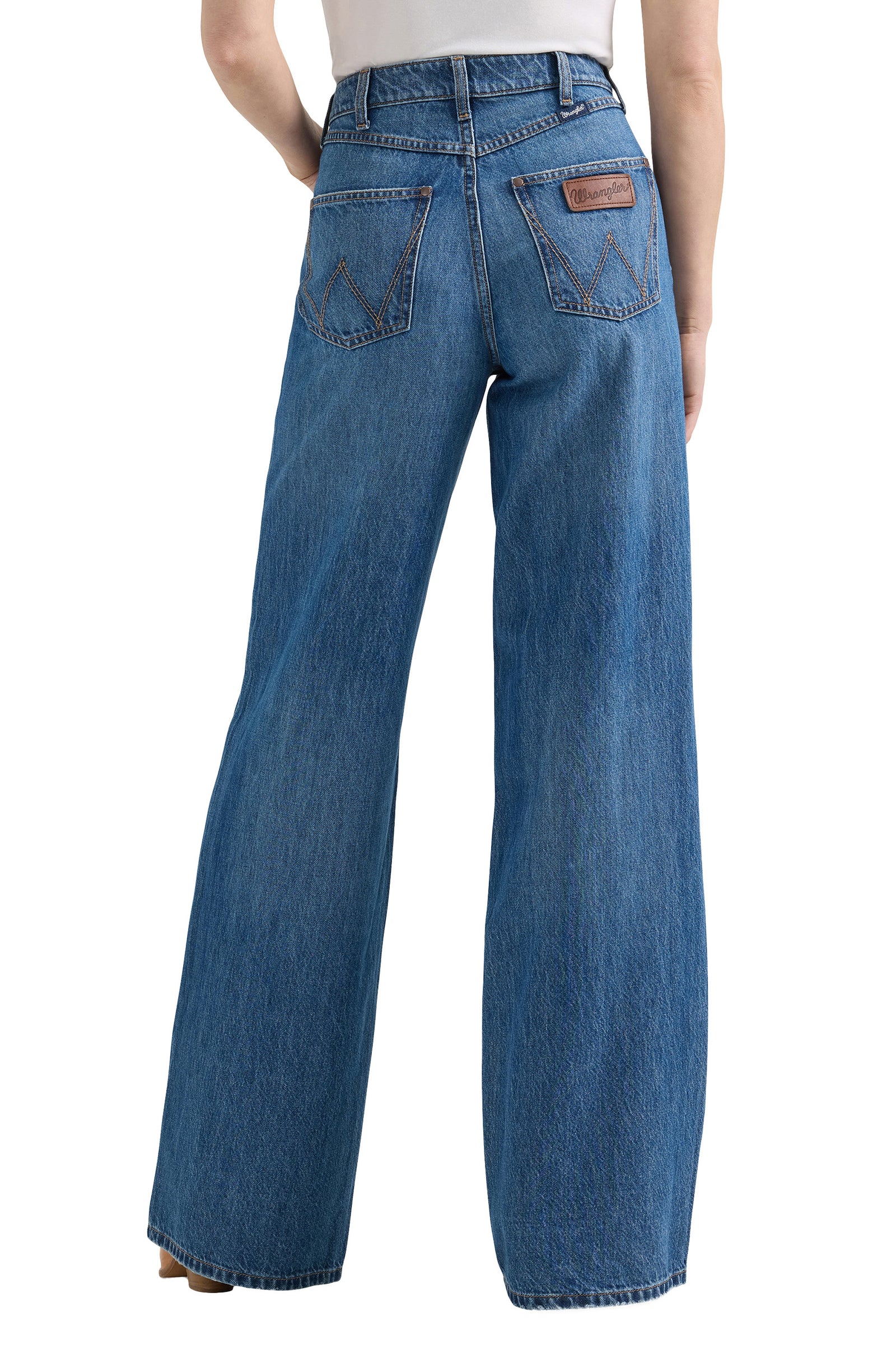 Blue jeans worn by a person on a white background