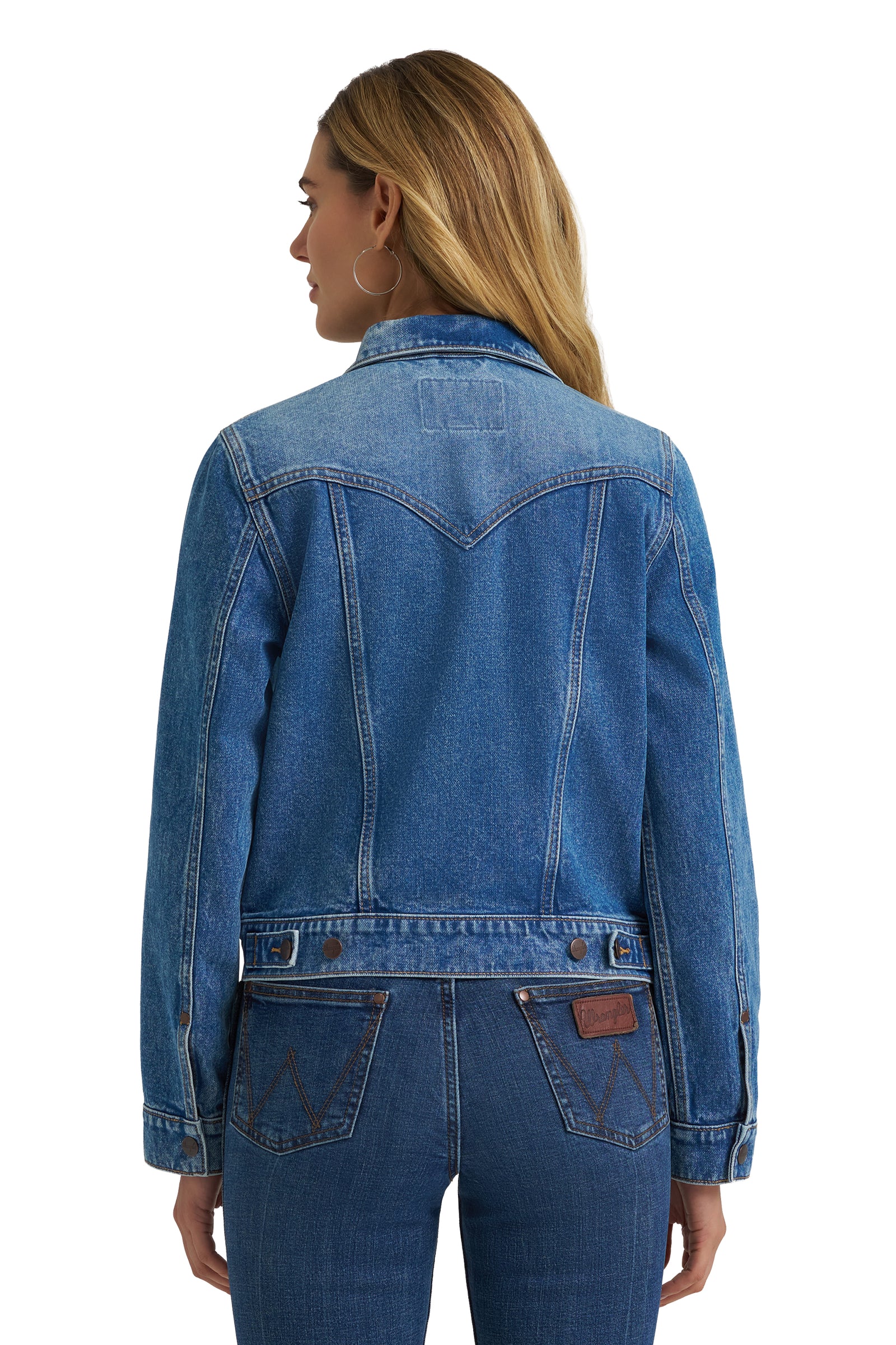 Person wearing a blue denim jacket on a white background