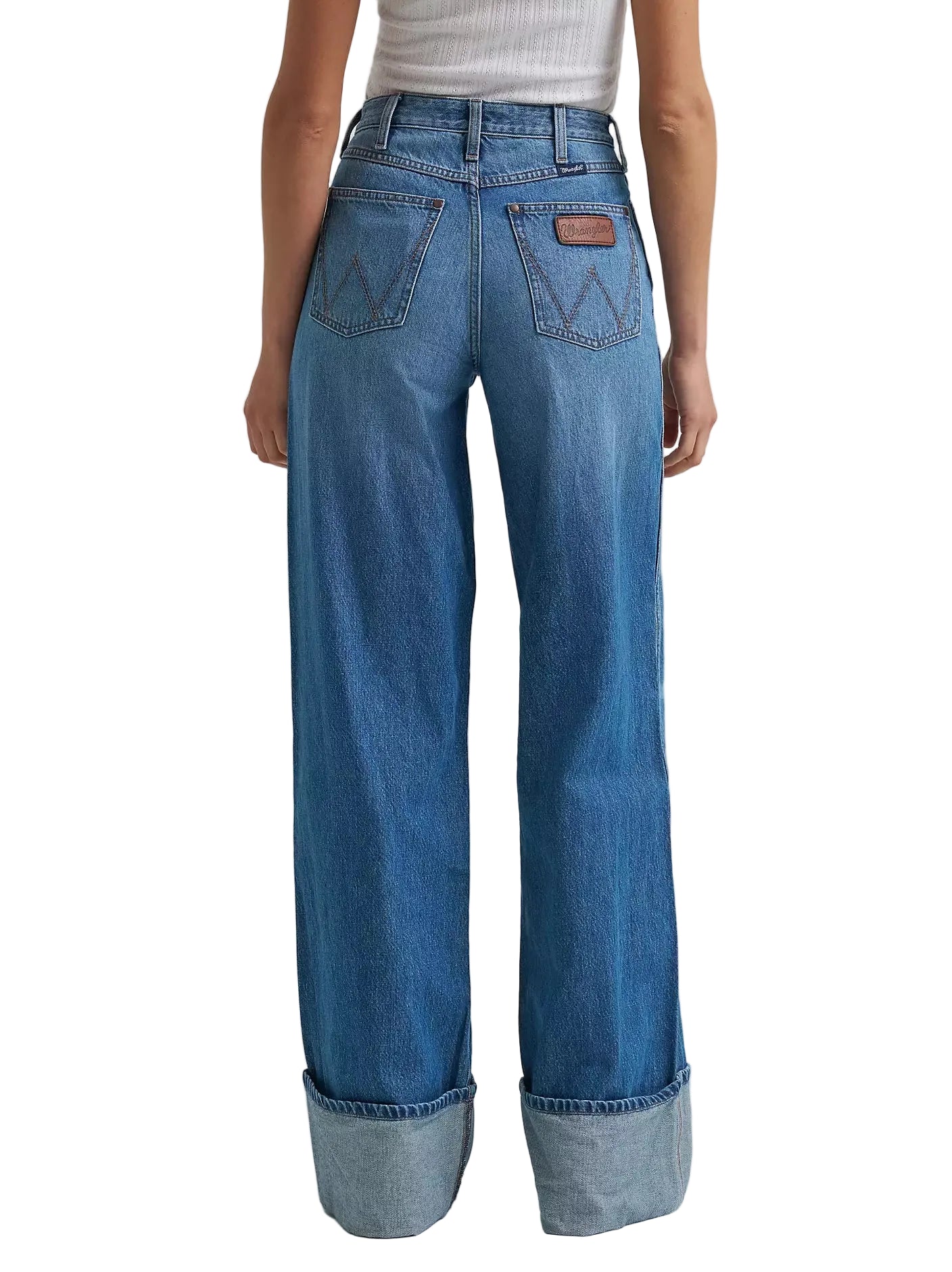 Blue jeans worn by a person on a light gray background