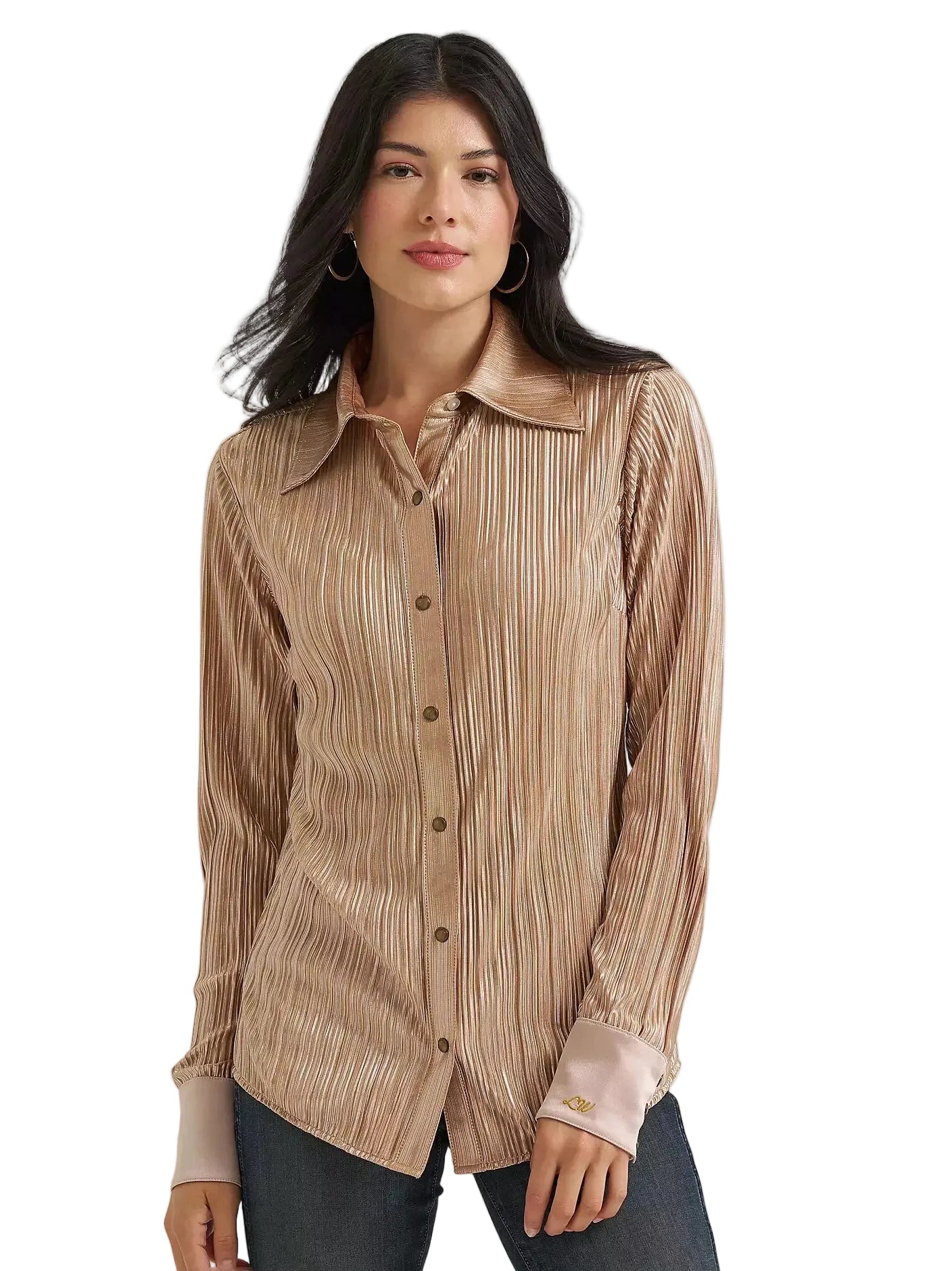 A woman modeling a long-sleeve button-up shirt with a vertical pleated texture in a warm beige and brown color palette, paired with dark jeans against a plain light gray background.