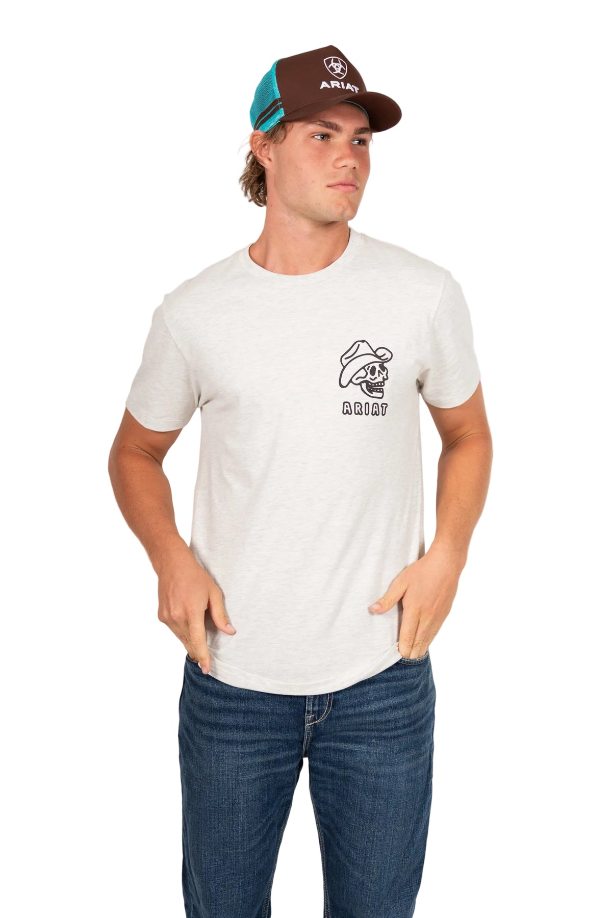 Ariat Stacked Logo Trucker Cap. Man wearing a white t-shirt with a logo and text, blue jeans, and a brown cap with a logo on a white background