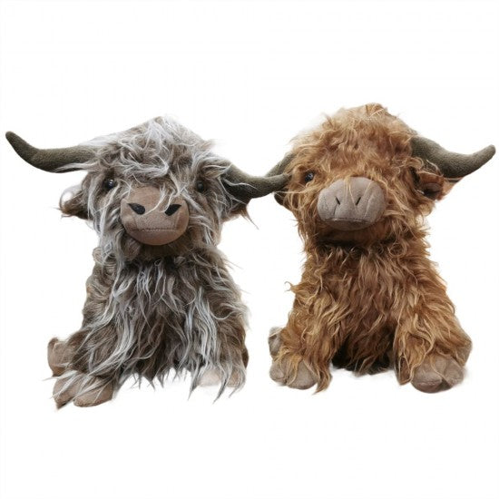 Two shaggy Highland cow plush toys side by side on a plain white background, one with gray and white fur and one with brown fur.