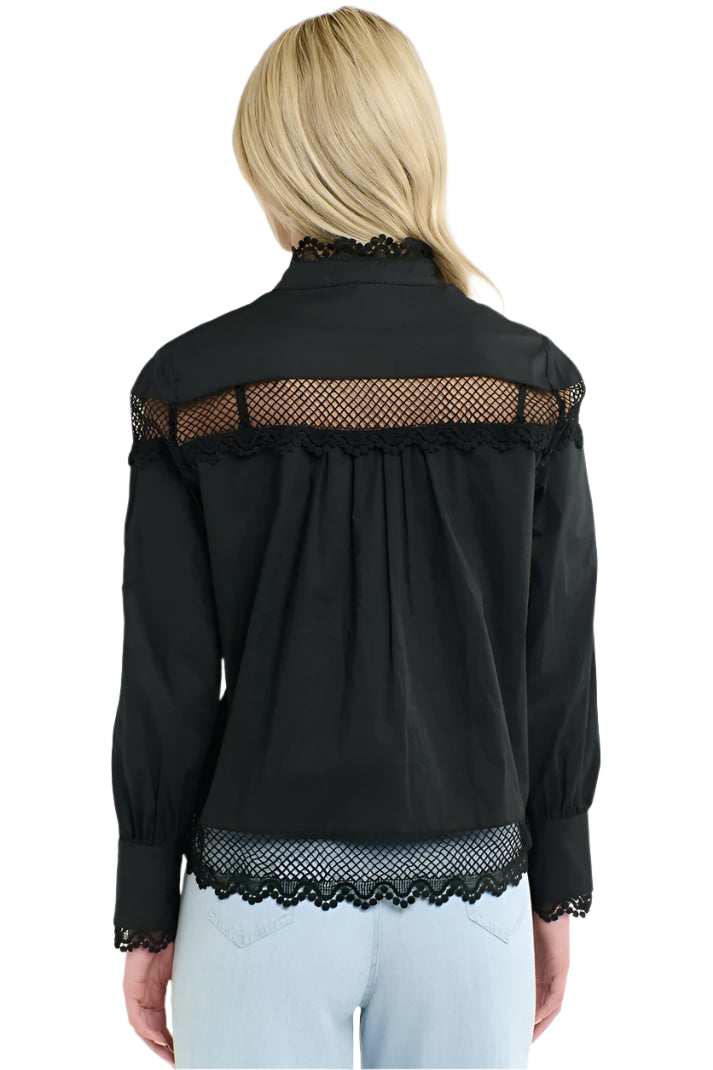 Woman wearing a 365 Women's Victoria Blouse. Black lace-trimmed with light blue jeans on a white background