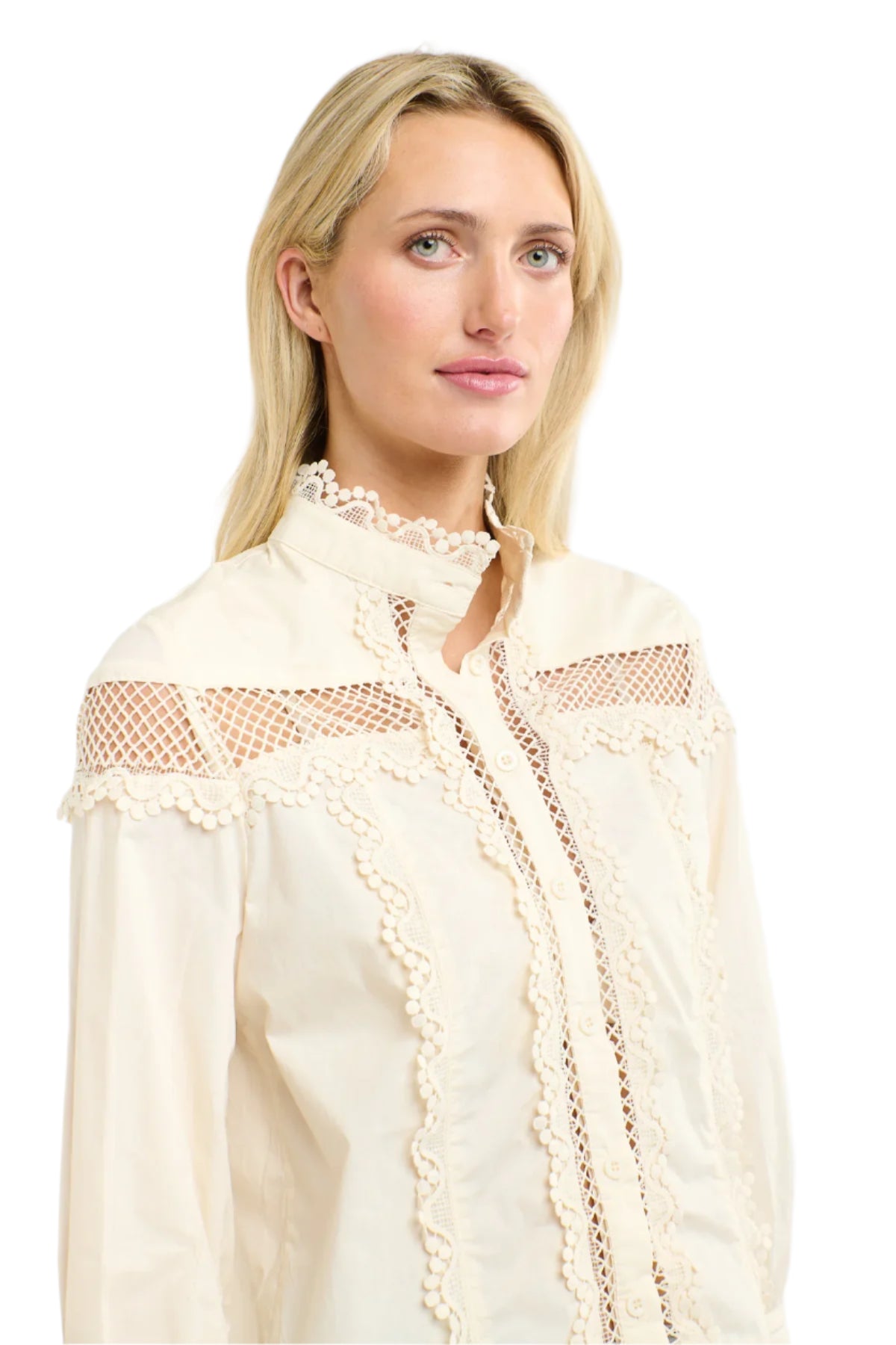 Woman wearing a 365 Women's Victoria Blouse. Vanilla lace-trimmed with light blue jeans on a white backgrouund