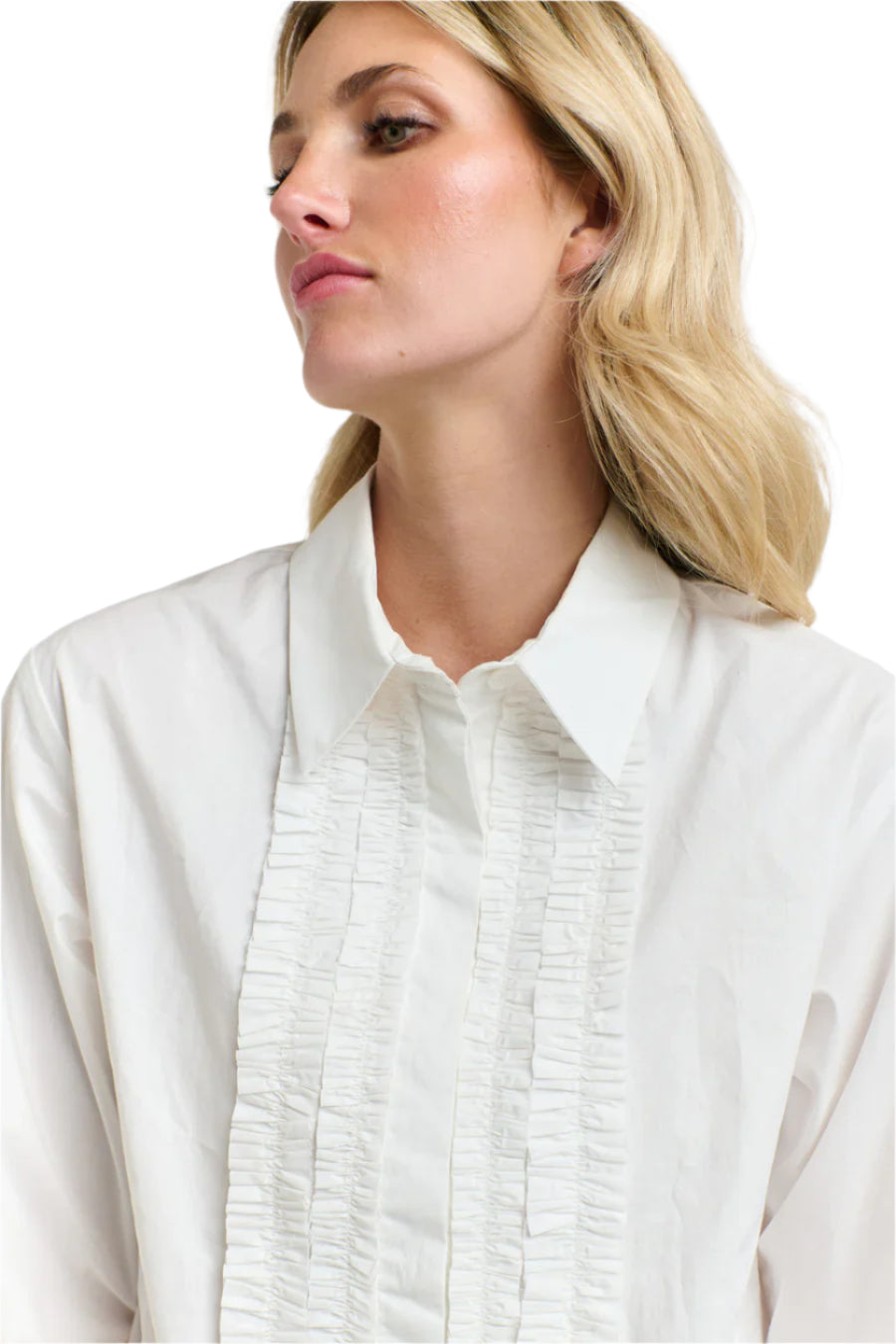 Close up of a woman wearing a 365 Women's Tuxedo Shirt. A white blouse with ruffled details on a white background