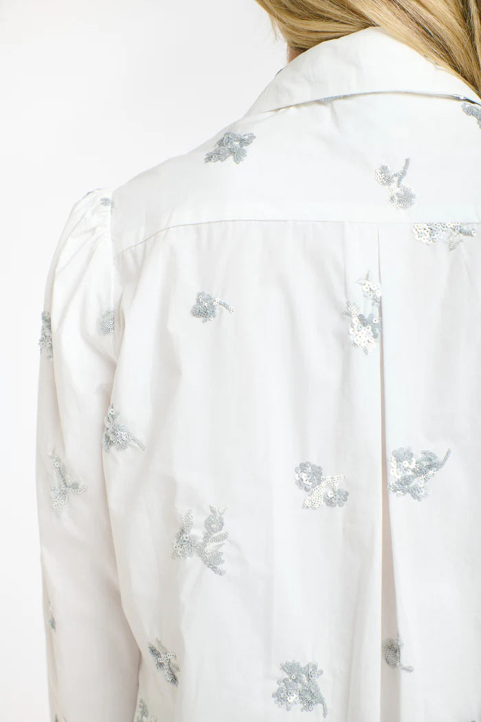 White blouse with floral patterns on a white background