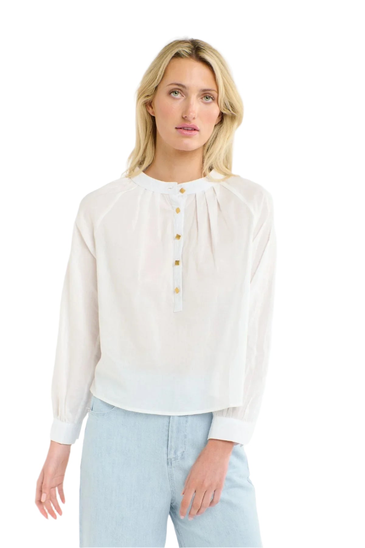 Woman wearing a 365 Women's Layla Cotton Top. A white blouse with gold buttons on a white background