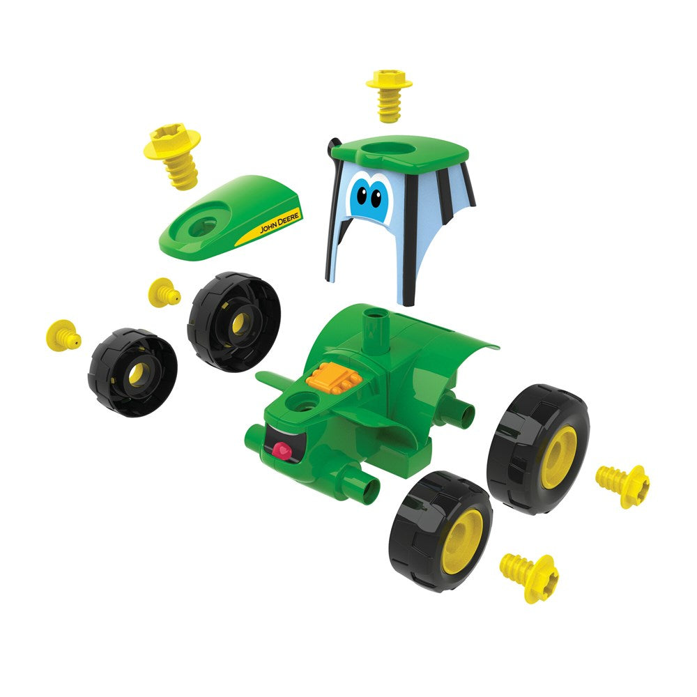 John Deere Build-A-Johnny Tractor. Toy tractor set with green body, black wheels, and yellow axles on a white background