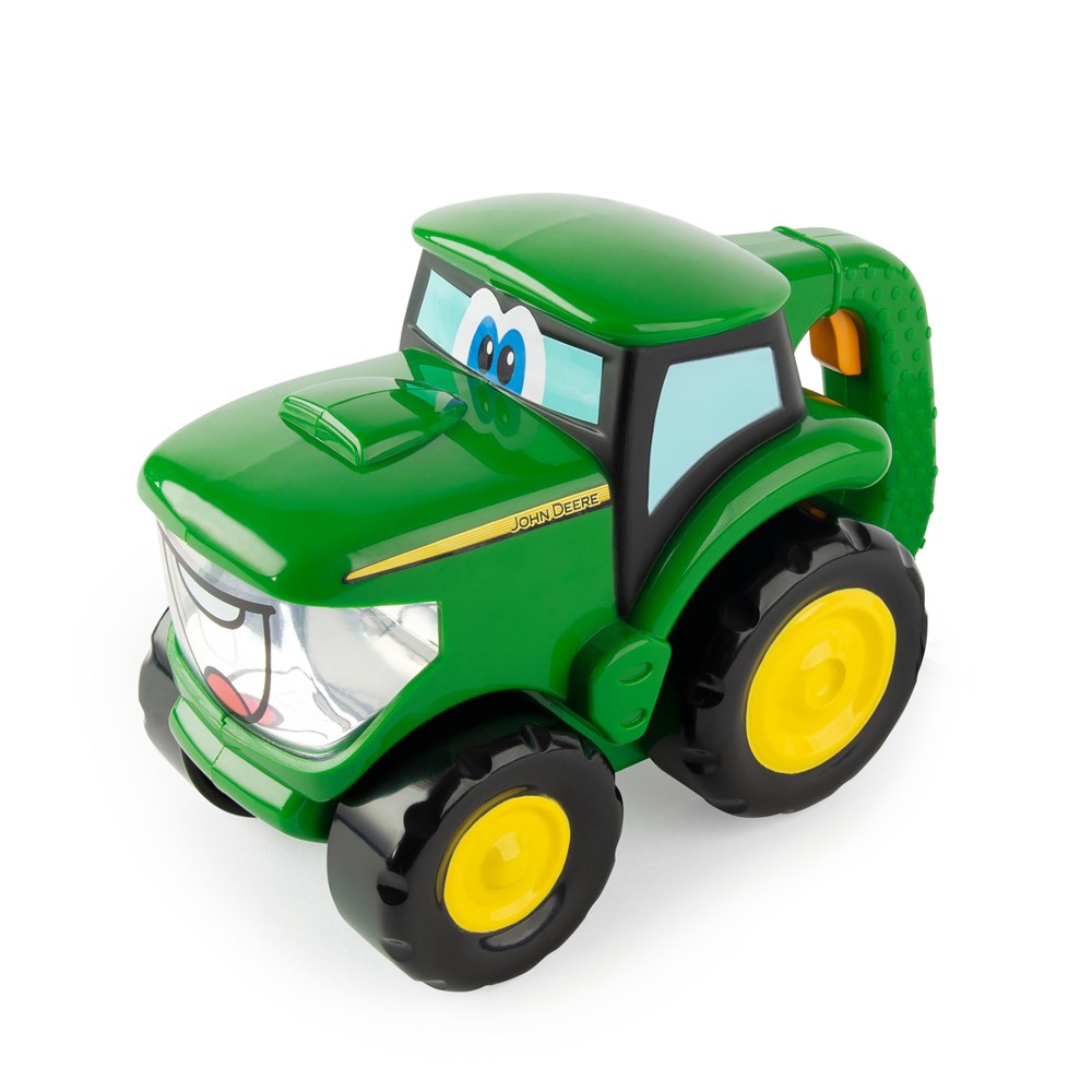 Toy tractor with a smiling face on a white background