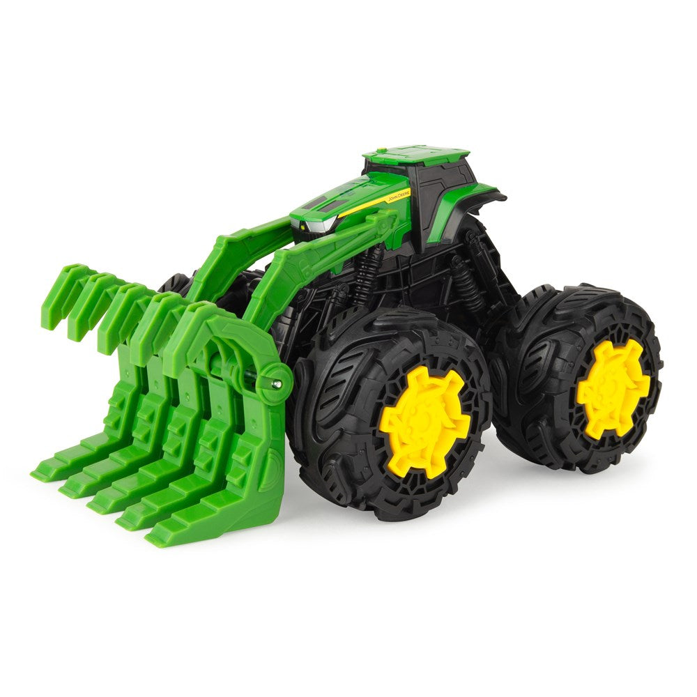 Toy tractor with green blades and black tires with yellow centers on a white background
