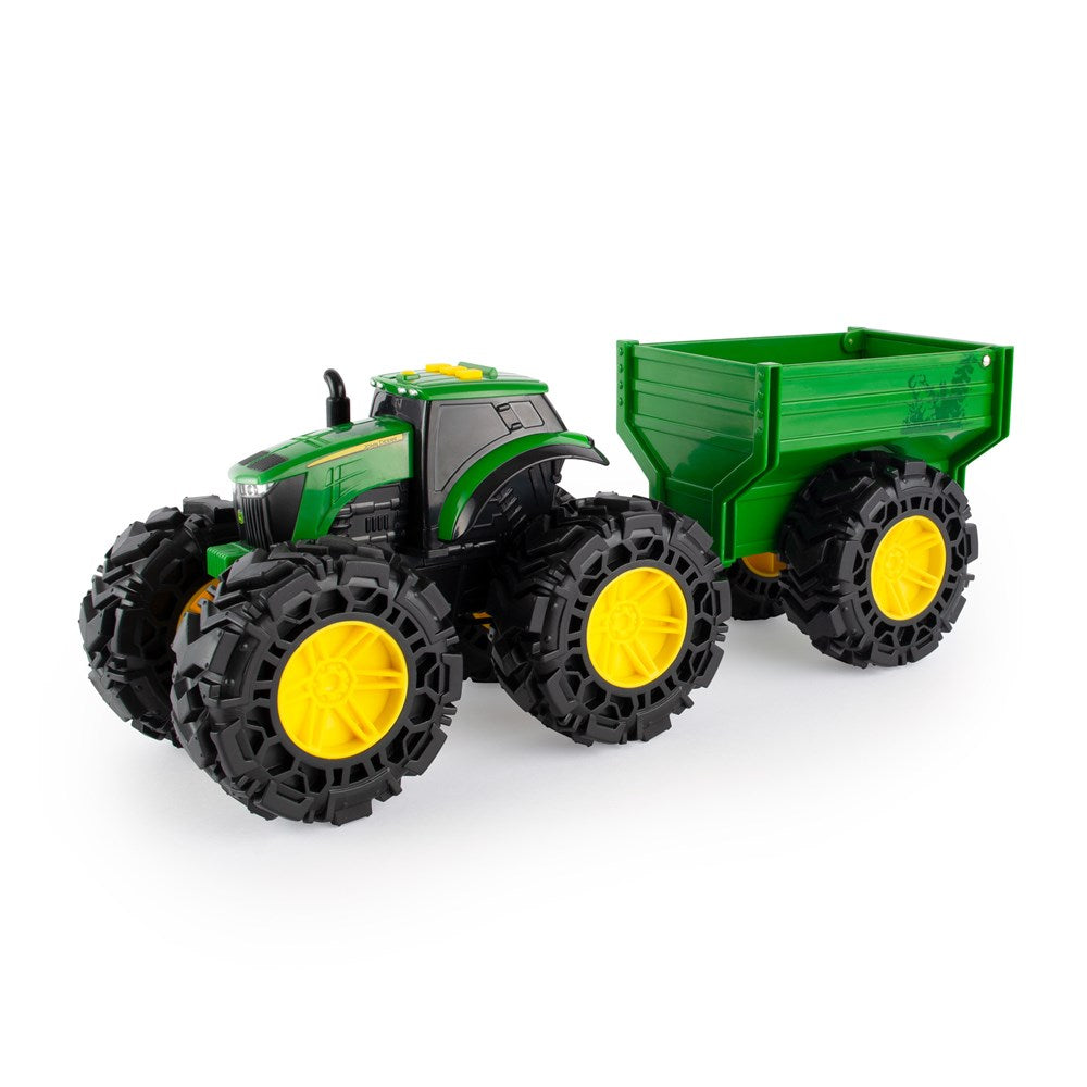 Toy tractor with large wheels and a trailer on a white background
