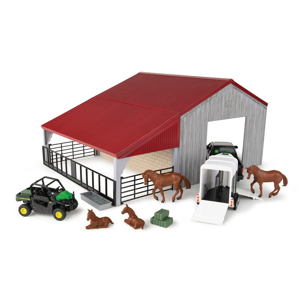 John Deere 1:32 Weathered Barn Play Set. Toy stable set with red roof, gray walls, and toy vehicles on a white background