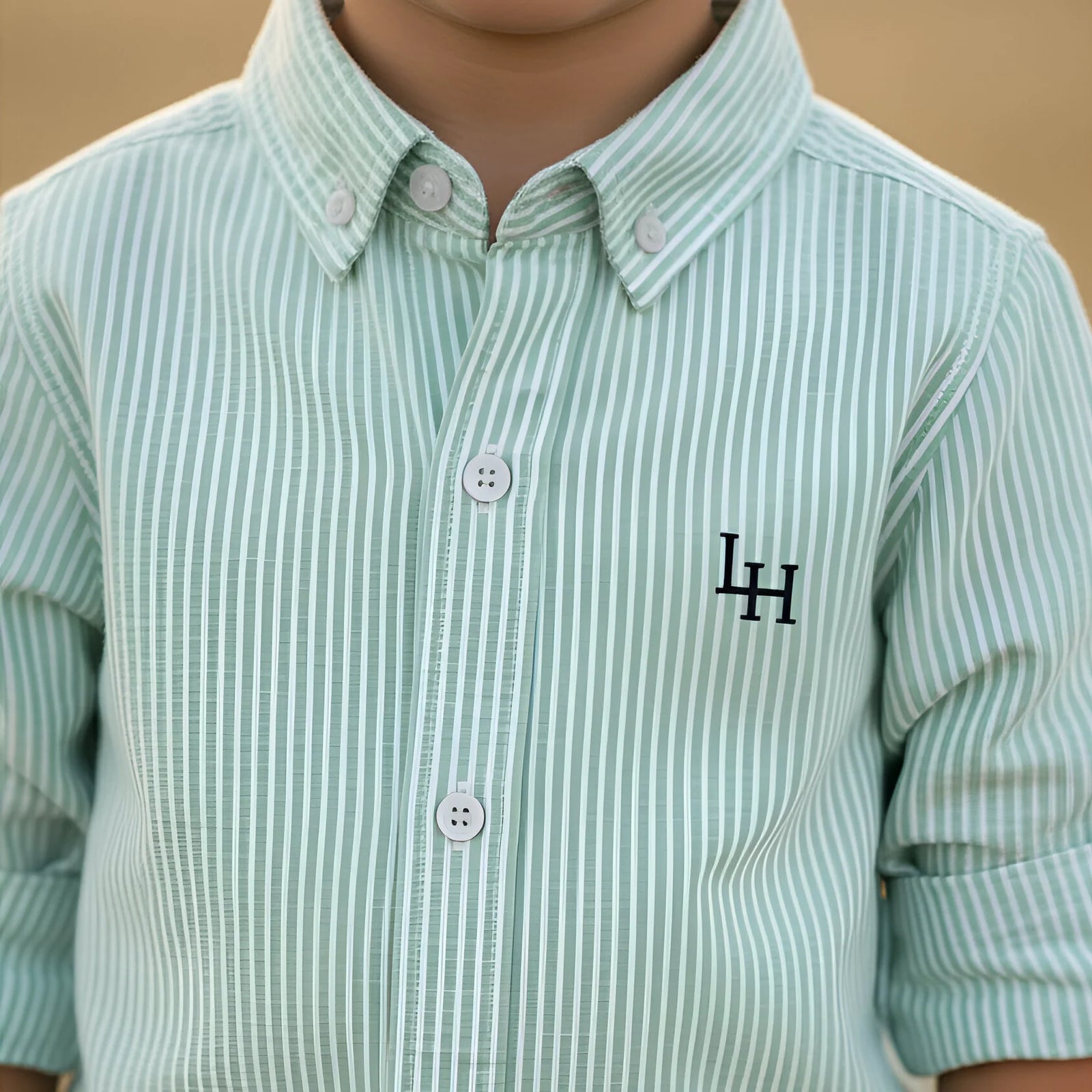 Green striped shirt with a logo on a plain background