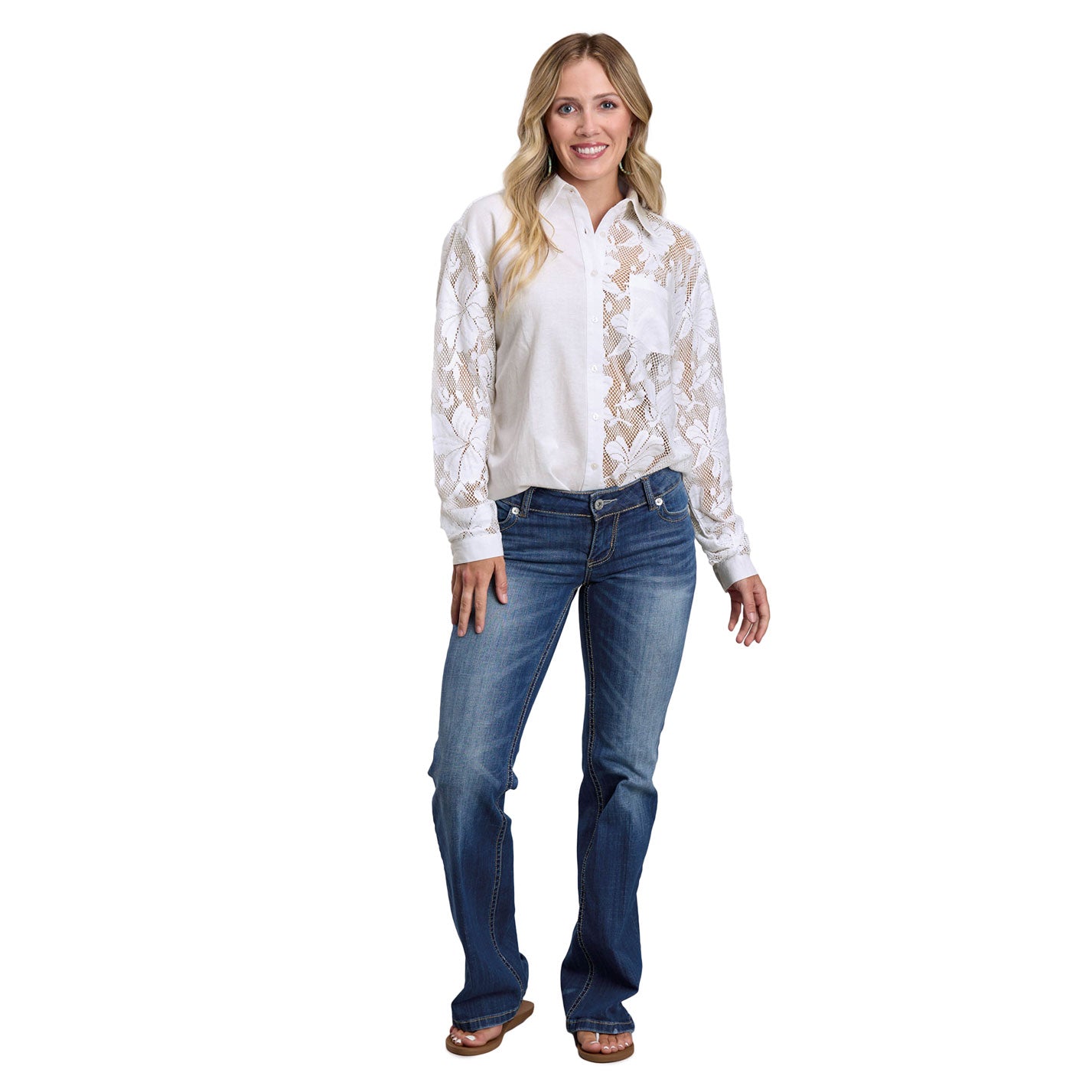 Woman wearing a white lace blouse and blue jeans on a white background