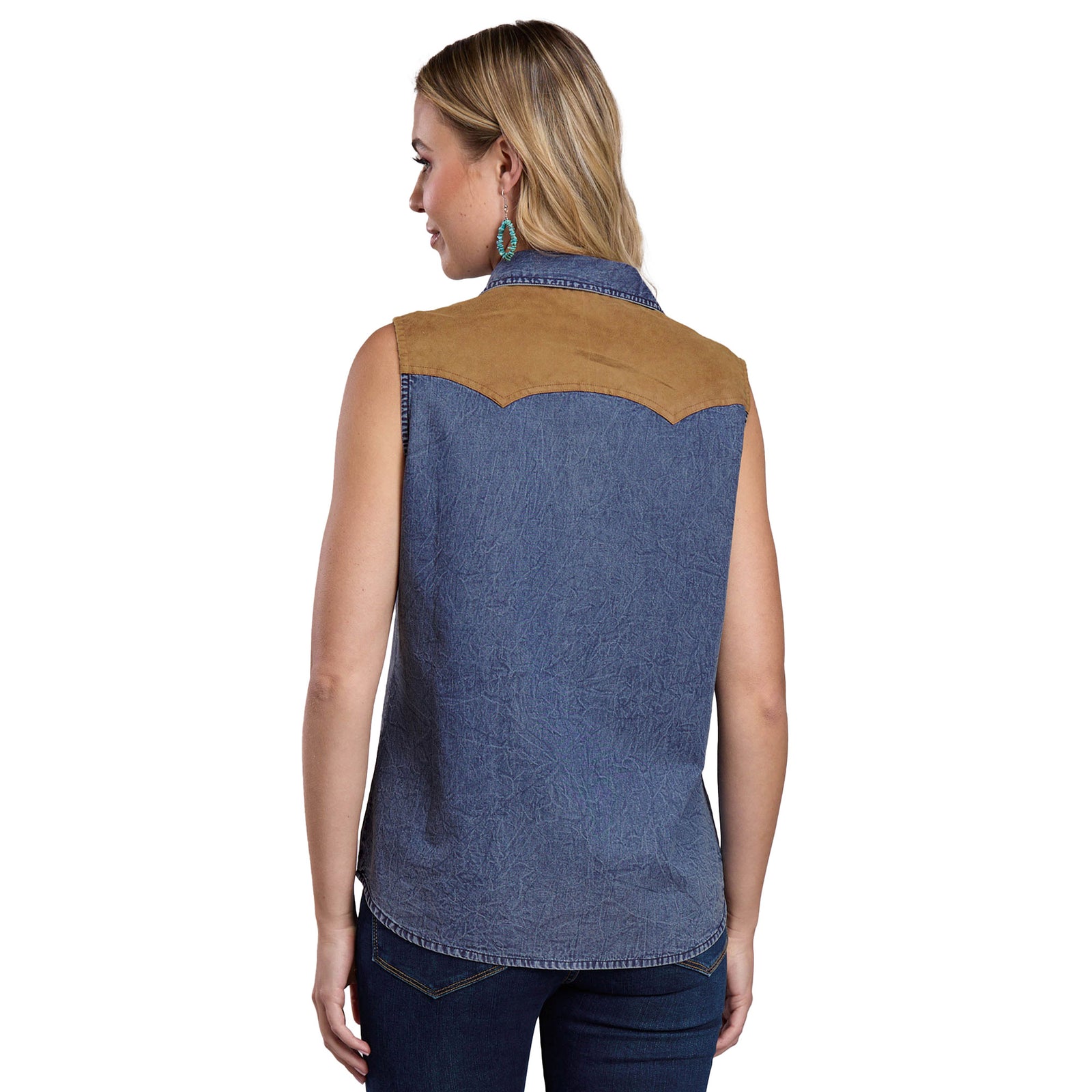 Woman wearing a denim vest with brown accents on a white background
