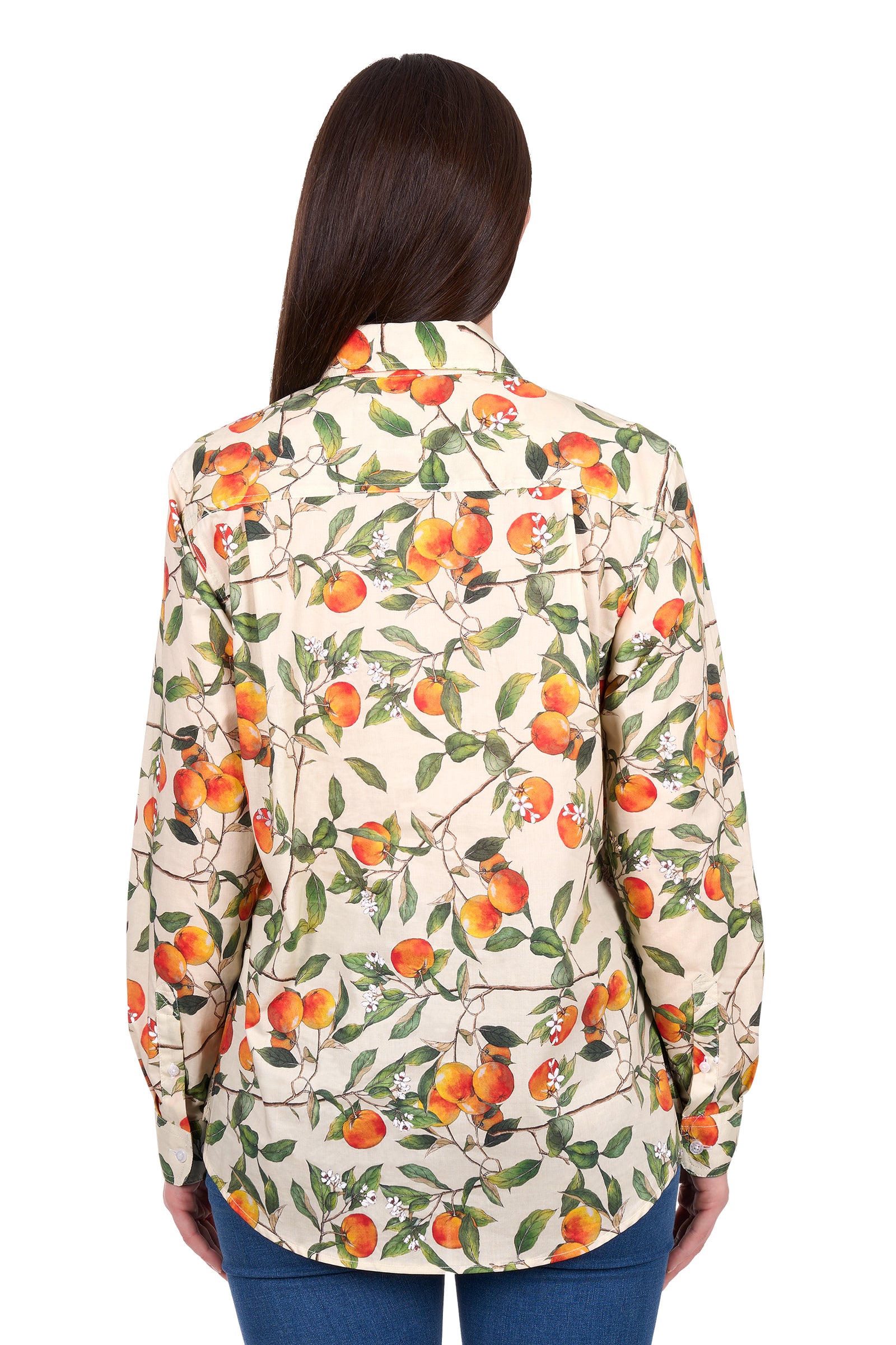 Woman wearing a floral patterned shirt with orange flowers on a white background