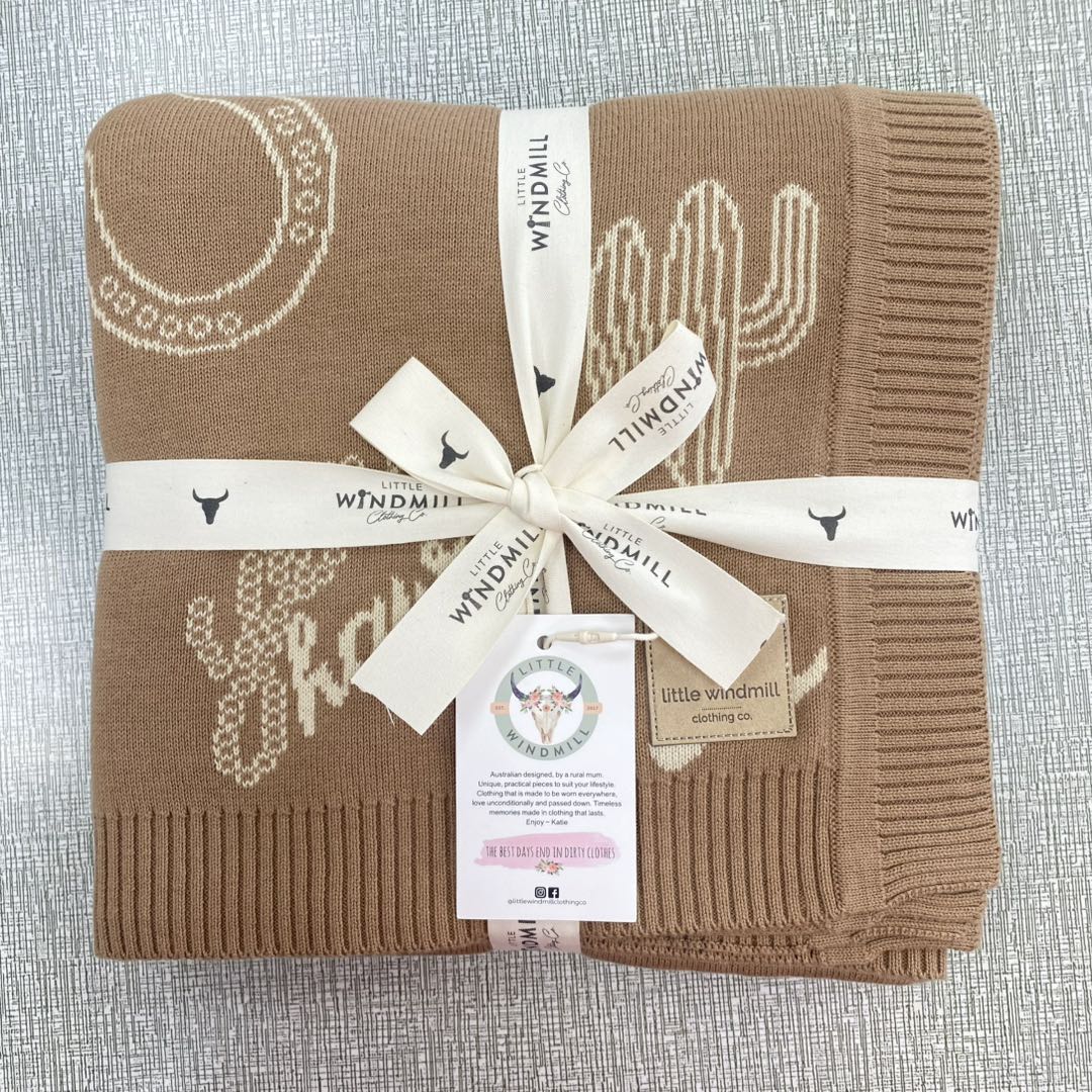 Brown knit blanket with cactus design and 'Little Windmill' branding on a gray background