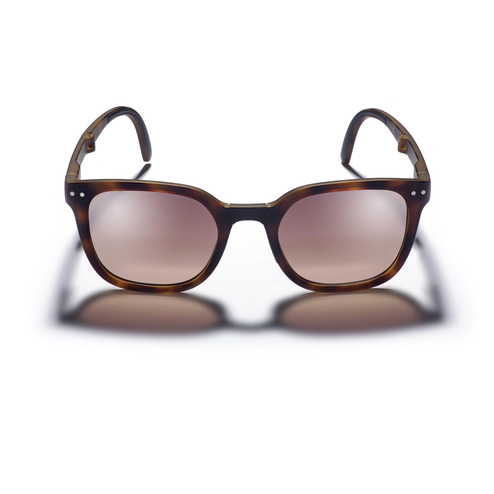 Sunglasses with tortoiseshell frame and brown lenses on a white background