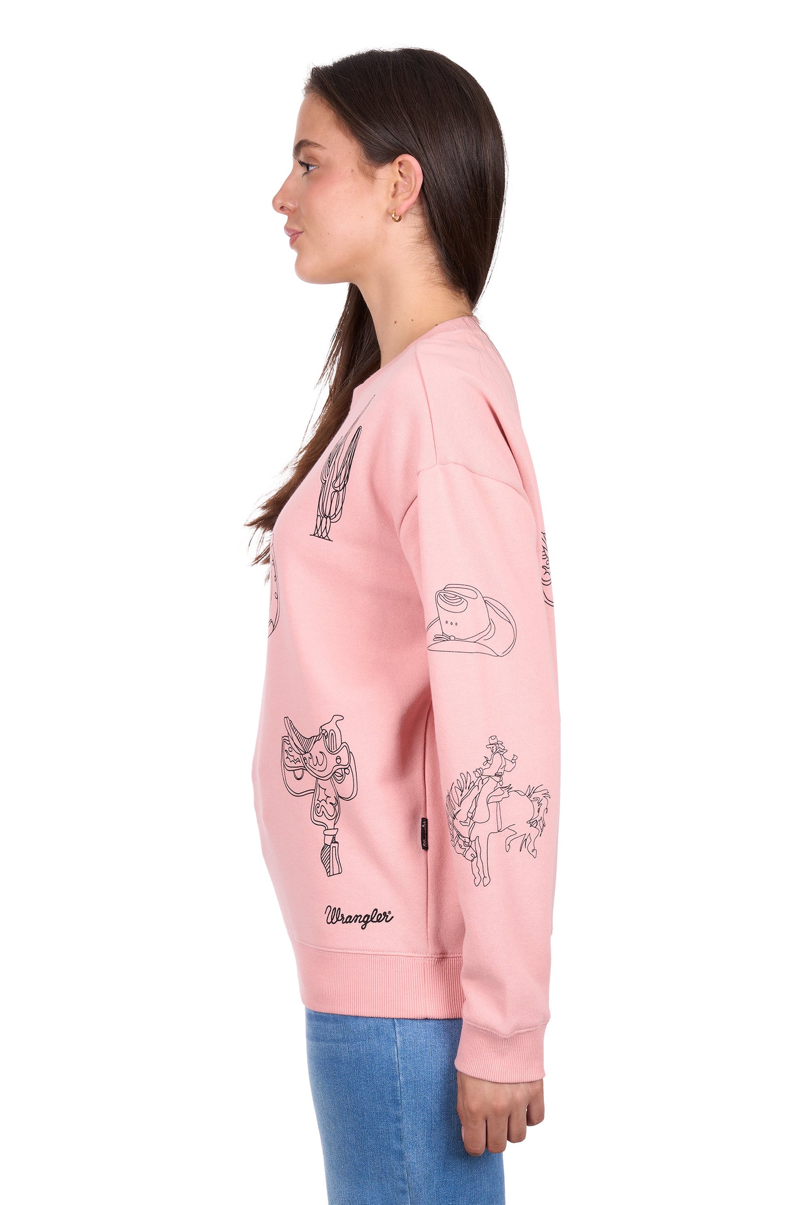 Person wearing a pink sweatshirt with cartoon designs on a white background