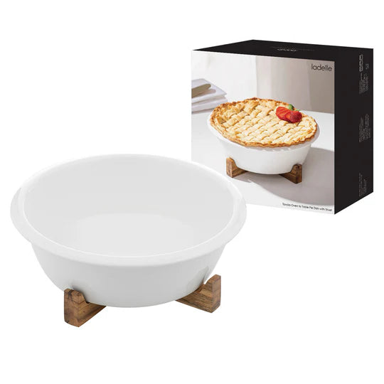 Alto Oven To Table Pie Dish With Trivet. White ceramic pie dish with wooden stand next to its packaging on a white background