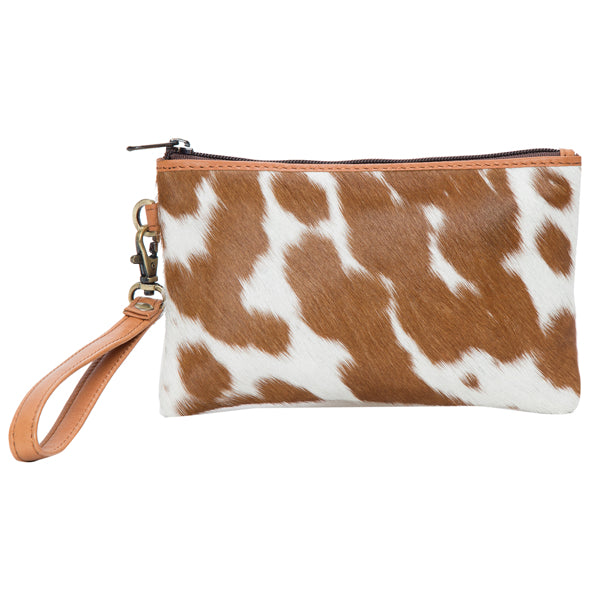 Women's Toronto Small Cowhide Clutch. Cow print clutch bag with a strap on a white background
