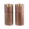 Two cylindrical wooden ashtrays with a warm brown wood grain finish and a polished gold metal notch at the top, shown side by side on a plain white background.