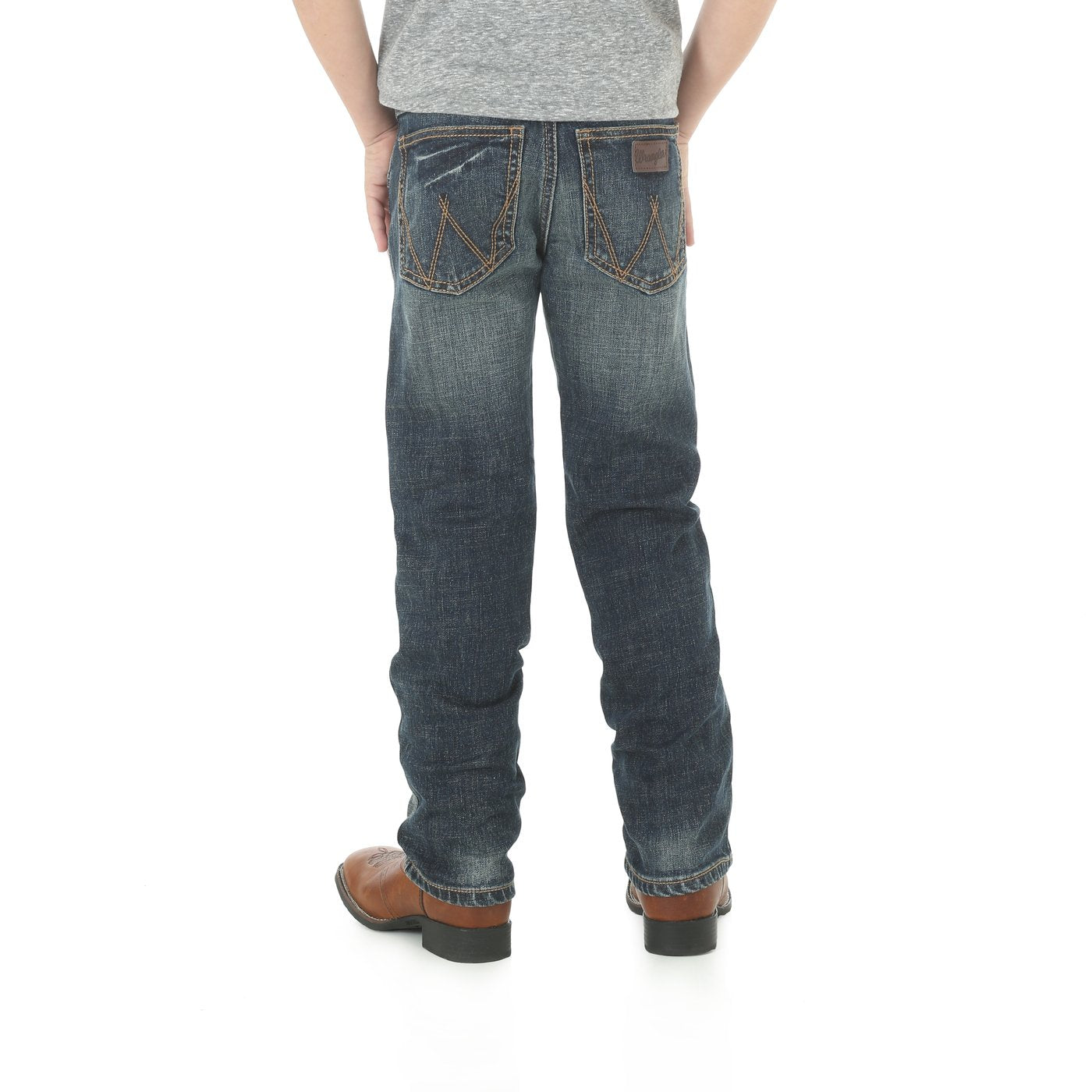 A pair of Wrangler slim straight leg jeans for boys, with a mid-rise waist and traditional five-pocket design, displayed against a white background.