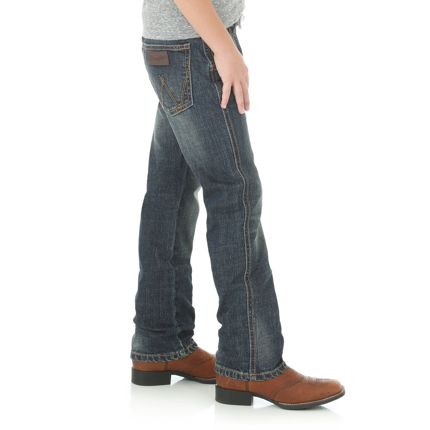 A pair of Wrangler slim straight leg jeans for boys, with a mid-rise waist and traditional five-pocket design, displayed against a white background.