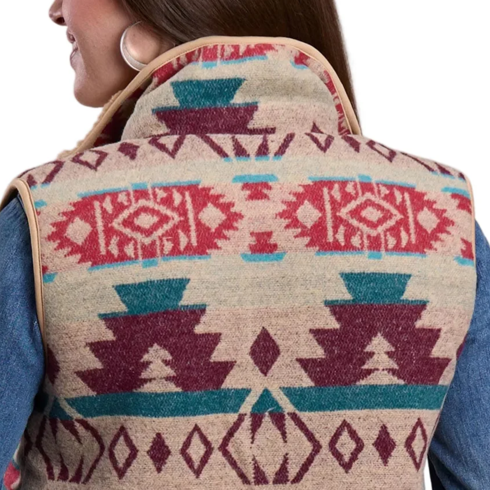 Person wearing a patterned vest with geometric designs.