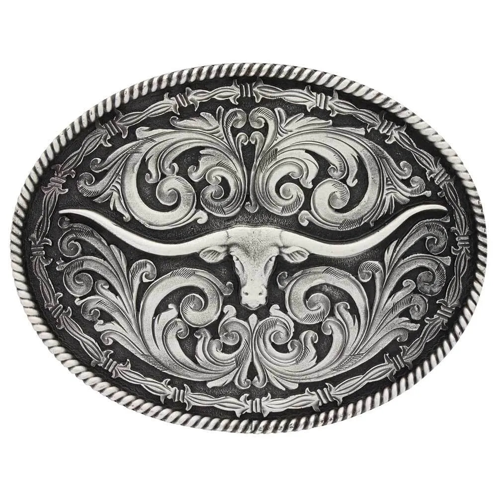 Montana Silversmith Rope & Barbed Wire Longhorn Buckle. A large oval-shaped belt buckle with an antiqued silver tone featuring a longhorn figure in the center, surrounded by traditional western filigree, barbed wire, and twisted rope trim.