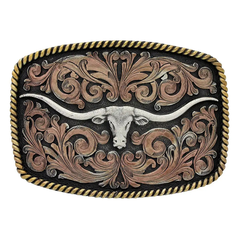 Montana Silversmiths Tri-Color Texas Longhorn Attitude Buckle. An elongated longhorn figure buckle with rose gold toned filigree and yellow gold toned rope edging on a silver background with a Montana Silversmiths logo.