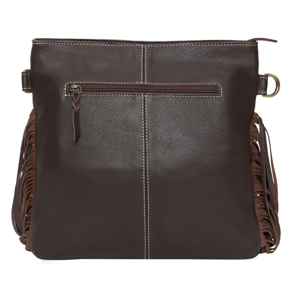 Pasto Tooling Leather Medium Sling Cowhide Bag. Brown leather handbag with fringe details on a white background