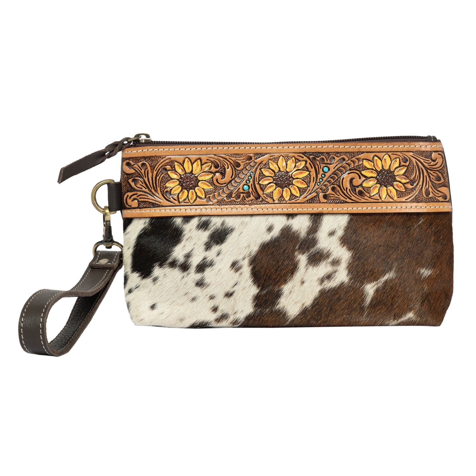 Wristlet with floral tooled leather design and cowhide leather surface on a white background