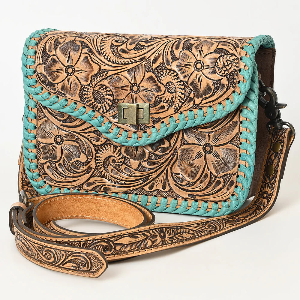 American Darling ooled Leather Crossbody Bag with Whipstitch Trim. Leather handbag with turquoise braided strap and intricate floral patterns on a white background