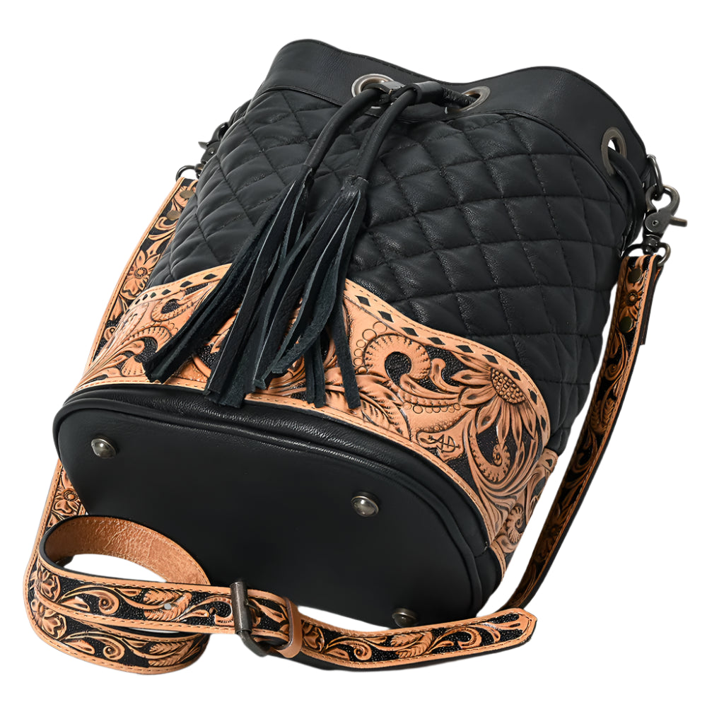 American Darling Black quilted leather western style bucket bag with intricate brown tooled leather strap on a white background